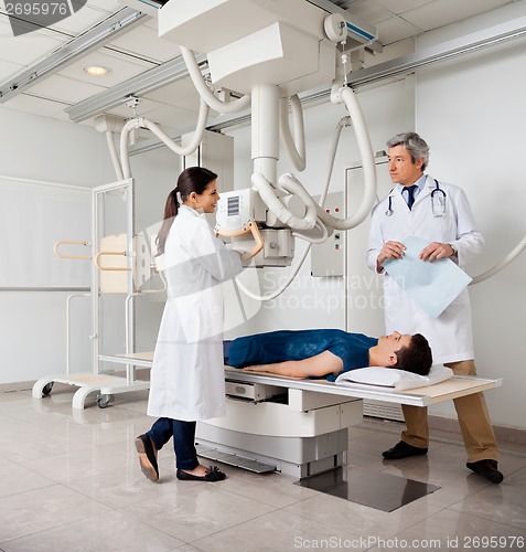 Image of Radiologists With Patient In X-ray Room