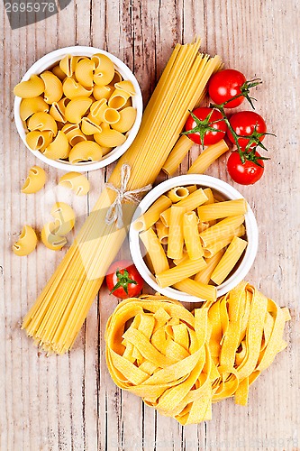 Image of uncooked pasta with tomatoes