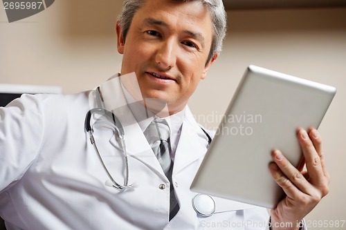 Image of Male Doctor Holding Digital Tablet