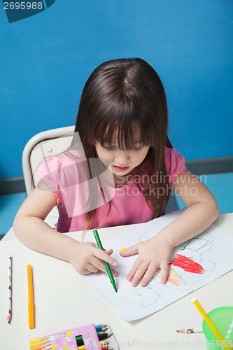 Image of Girl Drawing With Sketch Pen In Classroom