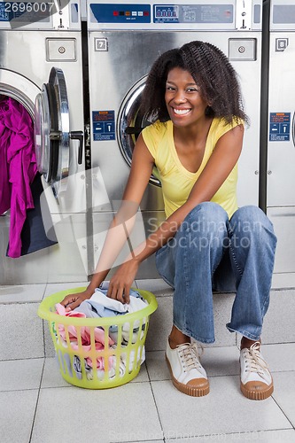 Image of Woman With Basket Of Clothes In Laundry