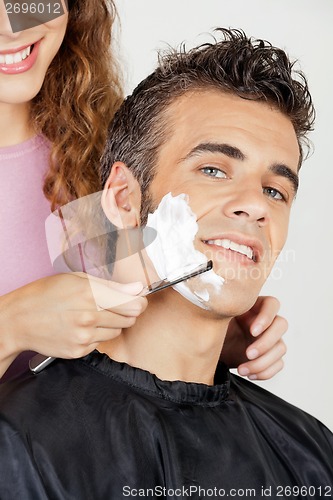 Image of Man Getting A Shave From Barber