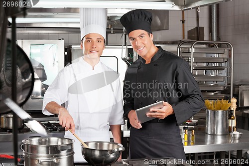 Image of Happy Chefs With Digital Tablet Cooking Food