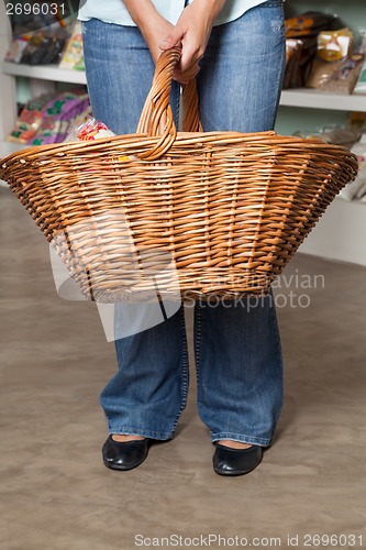 Image of Female Customer Carrying Wicker Basket