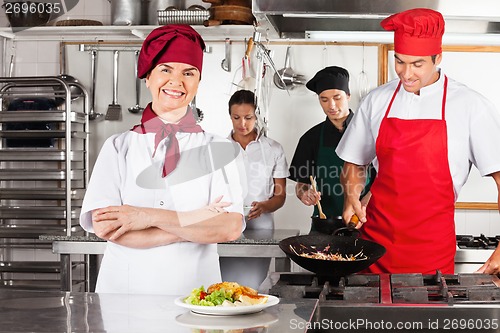 Image of Female Chef With Arms Crossed In Kitchen