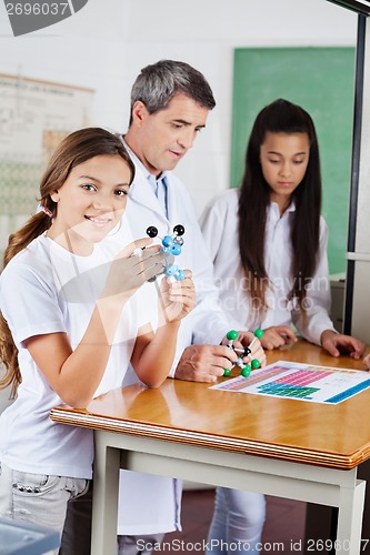 Image of Schoolgirl With Molecular Structure At Desk