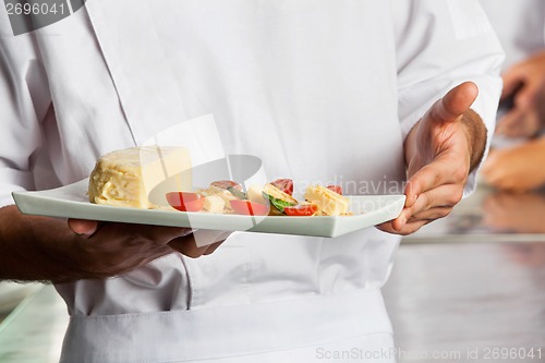 Image of Chef Presenting Dish