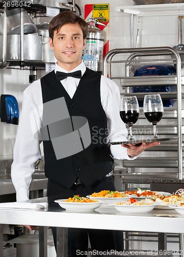 Image of Waiter Holding Wineglasses on Tray