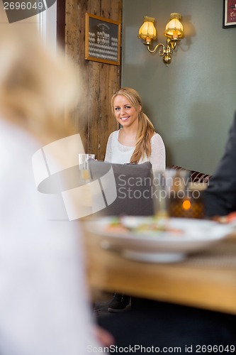 Image of Young Woman Sitting In Coffeeshop