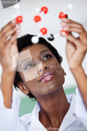 Image of Female Teacher Examining Molecular Structure