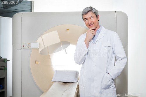 Image of Doctor Standing By Ct Scan Machine