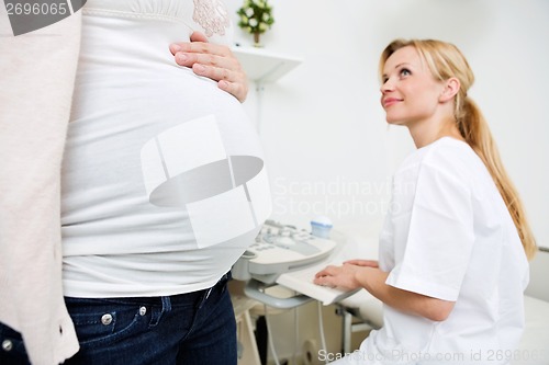 Image of Pregnant Woman With Doctor Preparing For Ultrasound Scan