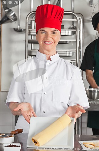 Image of Female Chef Presenting Chocolate Roll