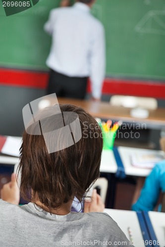 Image of Closeup Of Little Boy Sitting In Classroom