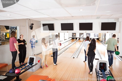 Image of Friends Bowling in Club