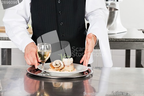 Image of Waiter With Salmon Roll And White Wine