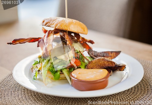 Image of Bacon Burger on Plate in Restaurant