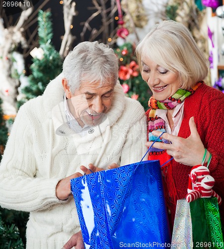 Image of Surprised Couple Looking Into Shopping Bag