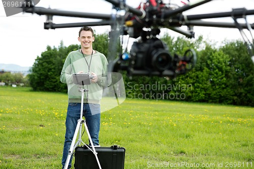 Image of Happy Engineer Operating UAV in Park
