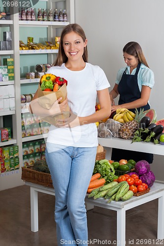 Image of Woman Holding Grocery Bag At Grocery Store