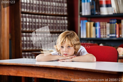 Image of Schoolboy Looking Away While Leaning On Table