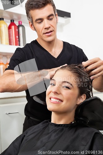 Image of Female Client Having Her Hair Washed In Salon