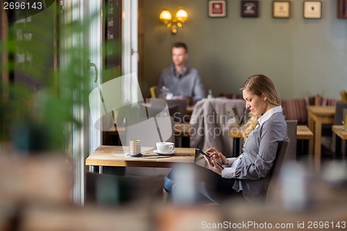 Image of Pregnant Woman Using Digital Tablet At Cafe