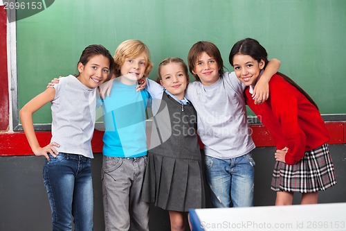 Image of Happy Schoolchildren With Arms Around Standing Together In Class