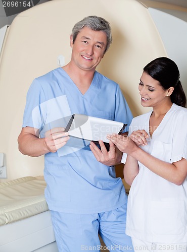 Image of Technicians Standing By MRI Scan Machine