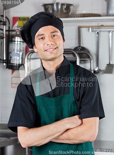 Image of Chef With Hands Folded Standing In Kitchen