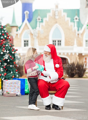 Image of Girl Giving Wish List To Santa Claus