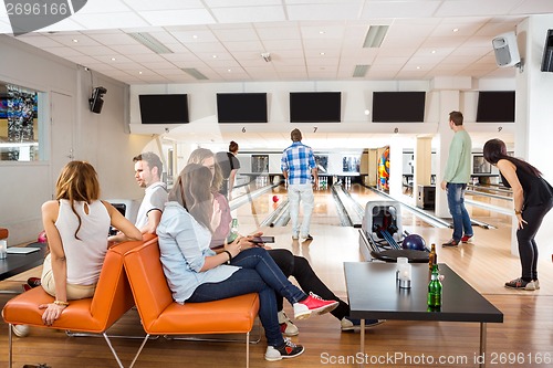 Image of Friends Spending Leisure Time in Bowling Club