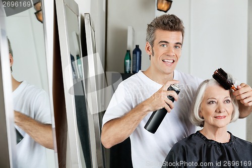 Image of Hairdresser Styling Client's Hair At Salon