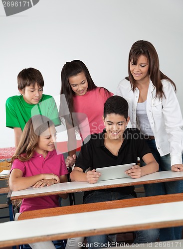 Image of Students Using Digital Tablet At Desk