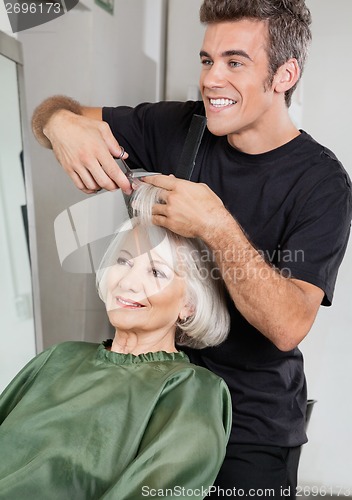 Image of Hairstylist Cutting Client's Hair In Parlor