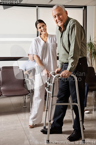 Image of Female Nurse Helping Senior Patient With Walker