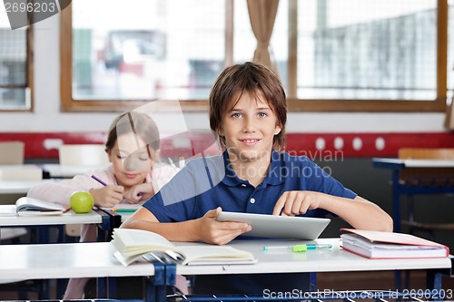 Image of Schoolboy Using Digital Tablet In Classroom