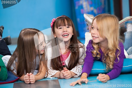 Image of Girls Lying On Floor In Kindergarten