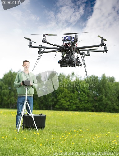 Image of Man Flying UAV Helicopter in Park