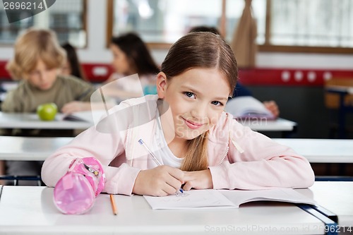 Image of Portrait Of Schoolgirl Drawing In Book