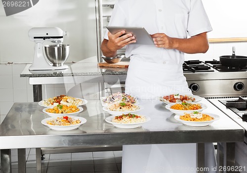 Image of Chef Using Digital Computer In Kitchen