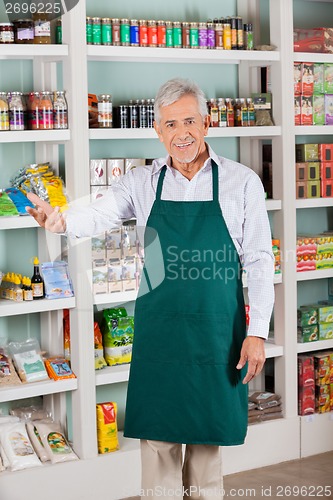 Image of Male Store Owner Gesturing In Supermarket