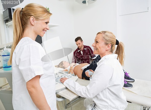 Image of Happy Obstetricians With Expectant Couple