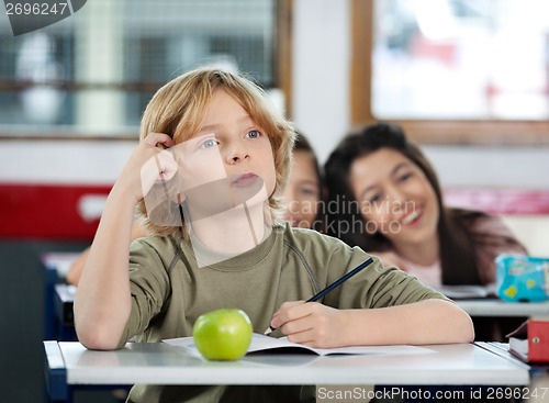 Image of Thoughtful Schoolboy Scratching Head