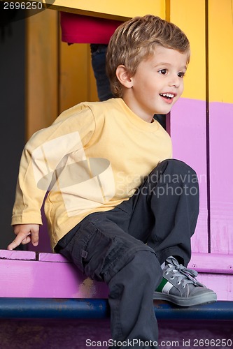 Image of Little Boy Playing At Playhouse