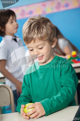 Image of Boy Holding Smith Apple