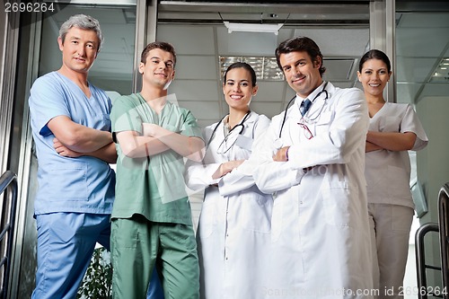 Image of Medical Professionals Standing With Hands Folded