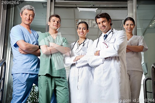 Image of Medical Professionals Standing With Hands Folded