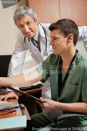 Image of Doctor With Technician At Clinic