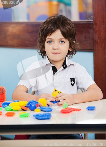 Image of Little Boy With Construction Blocks Playing In Class